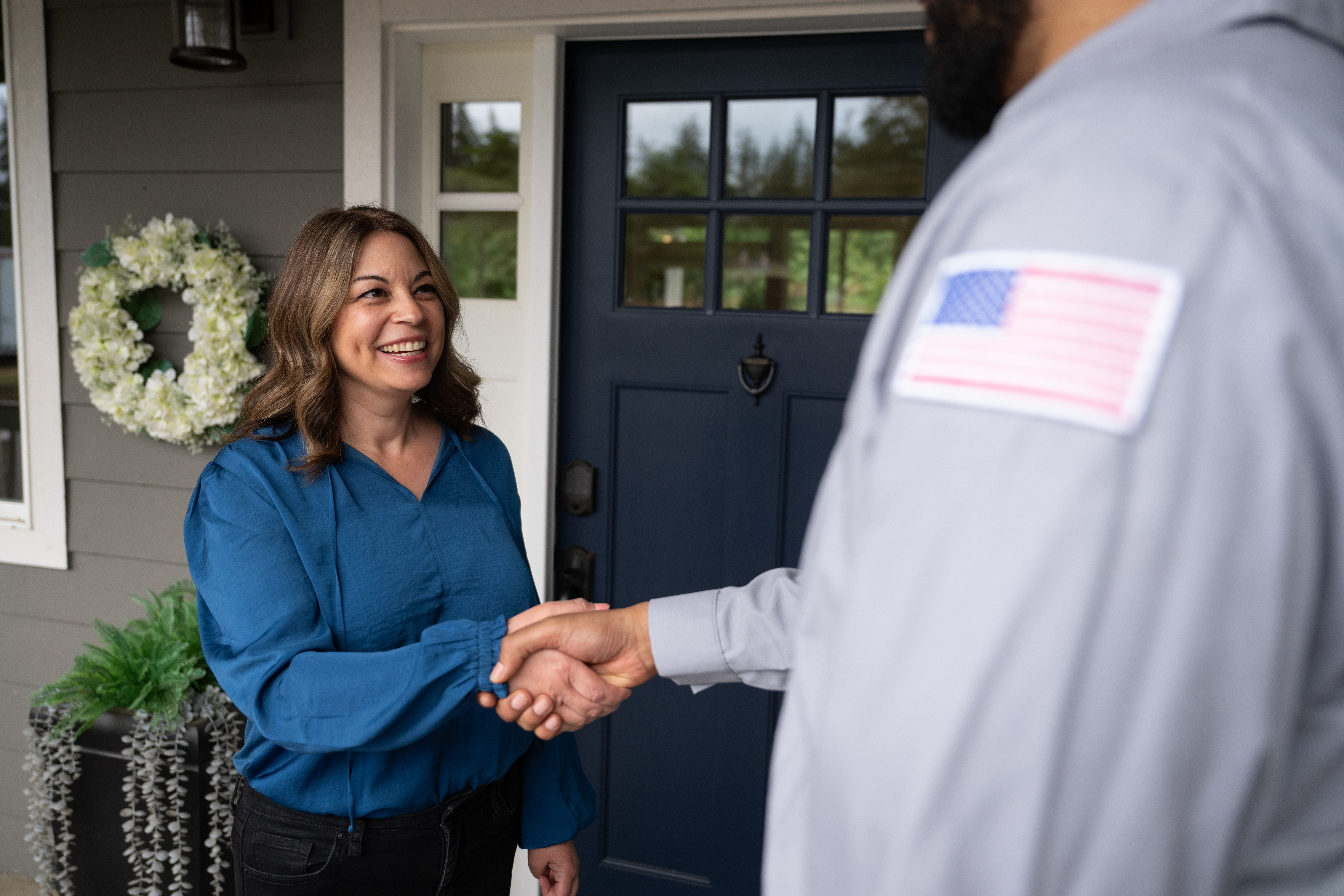 Customer shaking hands with South West plumber.